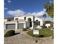 Charming two-story home with a well-manicured lawn and desert landscaping in a desirable neighborhood at 6724 W Behrend Dr, Glendale, AZ 85308