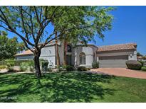 Charming single-story home with a well-manicured lawn, mature tree, and neutral color palette at 8120 E Cortez Dr, Scottsdale, AZ 85260