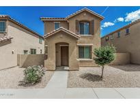 Charming two-story home featuring a covered entryway and well-maintained desert landscaping at 923 E Agua Fria Ln, Avondale, AZ 85323