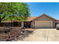 Charming single-story home featuring a private, gated courtyard and a two-car garage at 10211 W Hazelwood Ave, Phoenix, AZ 85037
