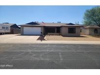 Charming single-story home with a well-maintained yard and an attached two-car garage at 11216 N 52Nd Ave, Glendale, AZ 85304