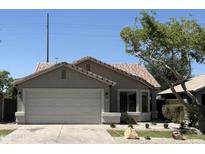 Charming single-story home featuring a two-car garage and well-maintained landscaping at 12586 W Amelia Ave, Avondale, AZ 85392