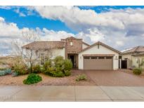 Charming single-story home with a well-manicured front yard and a two-car garage at 17909 W Agave Rd, Goodyear, AZ 85338