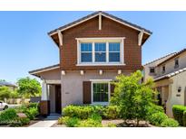 Charming home with brown shingle accents, lush landscaping, and inviting front entrance at 20565 W Terrace Ln, Buckeye, AZ 85396