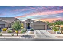 Charming single-story home with desert landscaping and a two-car garage beneath a colorful dusk sky at 22515 E Sonoqui Blvd, Queen Creek, AZ 85142