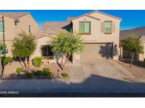 Charming two-story home featuring desert landscaping, neutral stucco, and a two car garage at 2361 N 212Th Dr, Buckeye, AZ 85396