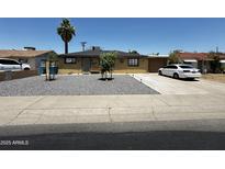 Charming single-story home featuring desert landscaping, a covered entryway, and a paved driveway at 2726 W Butler Dr, Phoenix, AZ 85051