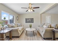 Bright living room with modern ceiling fan and neutral furniture, creating a welcoming atmosphere at 320 E Mckellips Rd # 46, Mesa, AZ 85201