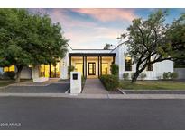 Charming single-Gathering home with manicured lawn and modern architectural details at 3825 E Coolidge St, Phoenix, AZ 85018
