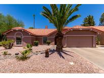 Charming single-story home boasts a desert-landscaped yard, a terracotta tile roof, and attached two-car garage at 5580 W Kesler St, Chandler, AZ 85226