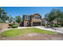 Charming two-story home with a well-manicured lawn and inviting front porch at 7274 W State Ave, Glendale, AZ 85303