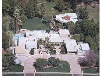 Expansive estate showcasing lush landscaping, a sparkling pool, and a circular driveway at 94 Biltmore Estates Dr, Phoenix, AZ 85016