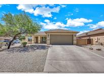 Charming home with neutral desert landscaping, tile roof, and a spacious two-car garage at 1147 E Harvest Rd, San Tan Valley, AZ 85140