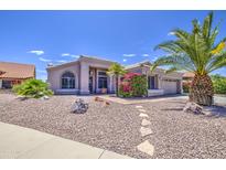 Charming single-story home featuring desert landscaping and a well-manicured yard with mature trees at 14039 S 33Rd Way, Phoenix, AZ 85044