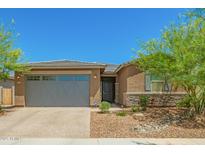 Charming single-story home featuring a two-car garage and drought-resistant landscaping at 17352 W Red Fox Rd, Surprise, AZ 85387
