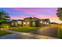 Charming single-story home with manicured lawn and a three-car garage at 17850 E Bronco Ct, Queen Creek, AZ 85142