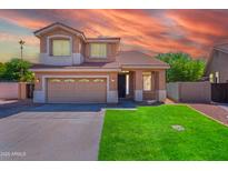 Charming two-story home featuring a well-manicured lawn and an attached two-car garage at 20277 N 68Th Dr, Glendale, AZ 85308