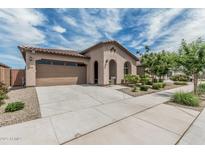 Inviting single-story home boasts a tile roof, a stucco exterior, a two-car garage, and a landscaped front yard at 23068 E Stacey Rd, Queen Creek, AZ 85142