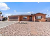 Charming single-story home featuring a two-car garage, desert landscaping, and a welcoming front porch at 2319 N 71St Dr, Phoenix, AZ 85035