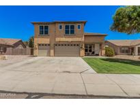 Charming two-story home featuring a large driveway and a well-maintained lawn at 3016 W White Canyon Rd, San Tan Valley, AZ 85144