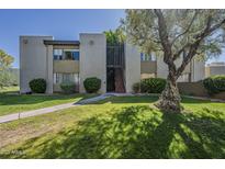 Condo exterior with mature landscaping and well-maintained lawn at 4201 E Camelback Rd # 74, Phoenix, AZ 85018