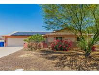 Charming single-story home featuring a two-car garage and desert landscaping with colorful flowering bushes at 4501 N 60Th Ave, Phoenix, AZ 85033