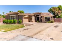 Charming single-story home with a well-maintained lawn, complemented by desert landscaping and a spacious driveway at 557 S Lemon Ct, Gilbert, AZ 85296