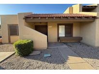 Charming single-story home with a tile roof and desert landscaping in front at 5813 W Gelding Dr, Glendale, AZ 85306