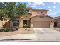 Two story home with a neutral stucco exterior, attached two-car garage and low maintenance desert landscaping at 9912 W Illini St, Tolleson, AZ 85353