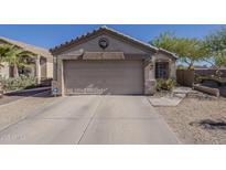 Beige single Gathering home featuring a two-car garage and a well-kept desert-style front yard at 11101 E Abilene Ave, Mesa, AZ 85208