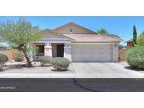 Inviting single-story home with a two-car garage, desert landscaping, and a charming covered porch at 1336 E Laurel Pl, Casa Grande, AZ 85122