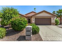 Charming single-story home with manicured landscaping and a two-car garage at 15011 W Verde Ln, Goodyear, AZ 85395