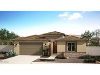 Charming single-story home featuring a two-car garage, a tile roof, and desert landscaping at 18048 W Larkspur Dr, Goodyear, AZ 85338