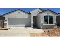 Charming one-story home with a two-car garage and modern stucco exterior at 18340 W Hackamore Dr, Wittmann, AZ 85361