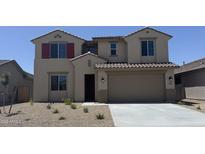 Charming two-story home with a well-maintained front yard and two-car garage, offering curb appeal at 18365 W Villa Hermosa Ln, Surprise, AZ 85387