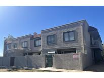 A well-maintained two-story townhome featuring a stucco exterior and a red tile roof at 2311 E Hartford Ave # 38, Phoenix, AZ 85022