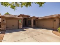 Attractive single-story home featuring a three-car garage and desert landscaping at 2990 N Pearl Ct, Casa Grande, AZ 85122