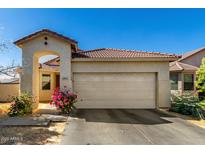 Charming single-story home with a tile roof, two-car garage, and well-maintained landscaping at 5654 W Vineyard Rd, Laveen, AZ 85339