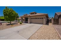 Charming single-story home with desert landscaping, a tile roof, and a spacious two-car garage at 9074 W Runion Dr, Peoria, AZ 85382