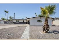Charming single-story home featuring desert landscaping and solar panels on the roof at 1066 E 7Th Pl, Mesa, AZ 85203