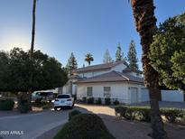 Elegant two-story home with a tile roof, a paved driveway, and a well-maintained landscaped yard at 1454 E Calle De Arcos --, Tempe, AZ 85284