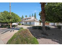 Charming two-story home with well-maintained landscaping and a circular driveway, exuding curb appeal at 1454 E Calle De Arcos --, Tempe, AZ 85284