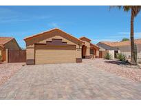 Charming single-story home with desert landscaping, tile roof, and paved driveway at 18130 N 92Nd Ln, Peoria, AZ 85382