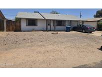 Modest single-story home with low maintenance landscaping, attached garage, and a neutral exterior paint at 1843 S Papago Dr, Apache Junction, AZ 85120