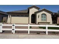 Charming single-story home features desert landscaping and a neutral color palette at 18941 W Monterosa St, Litchfield Park, AZ 85340