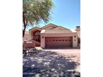 Charming single-story home featuring a two-car garage, desert landscaping, and inviting curb appeal at 25150 N Windy Walk Dr # 14, Scottsdale, AZ 85255