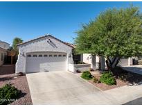 Charming single-story home featuring a two-car garage, desert landscaping, and a well-maintained front yard at 26243 W Wahalla Ln, Buckeye, AZ 85396
