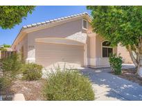 Charming home featuring a neutral stucco facade, a two-car garage, and well-maintained desert landscaping at 2729 N Kenton St, Mesa, AZ 85215