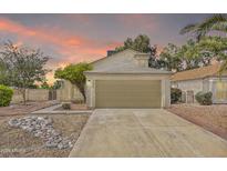 Charming single-Gathering home featuring an attached two-car garage and a well-manicured front yard at sunset at 3855 W Denver St, Chandler, AZ 85226