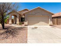 Charming single-story home featuring a two-car garage and covered front porch at 4942 W Novak Way, Laveen, AZ 85339